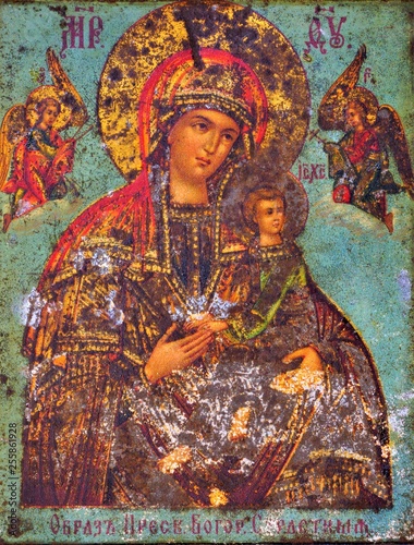 Virgin Mary and baby Jesus, ancient icon. The virgin Mary enjoys great reverence in Christianity, allows believers to find protection and hope. Madonna sits on a shining throne, holding baby-Jesus.