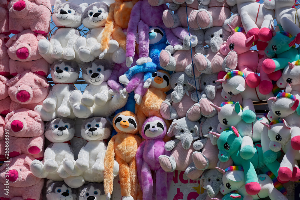A wall of plush stuffed toy prizes at a carnival.