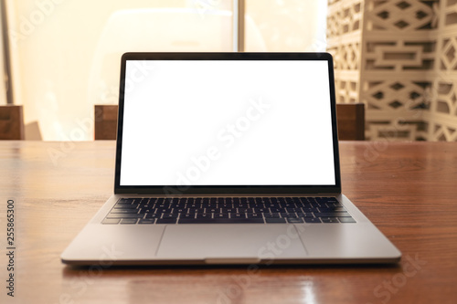 Fototapeta Naklejka Na Ścianę i Meble -  Mockup image of laptop with blank white desktop screen on wooden table