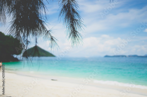 tourists walking along the beautiful beach of He island in Phuket Thailand