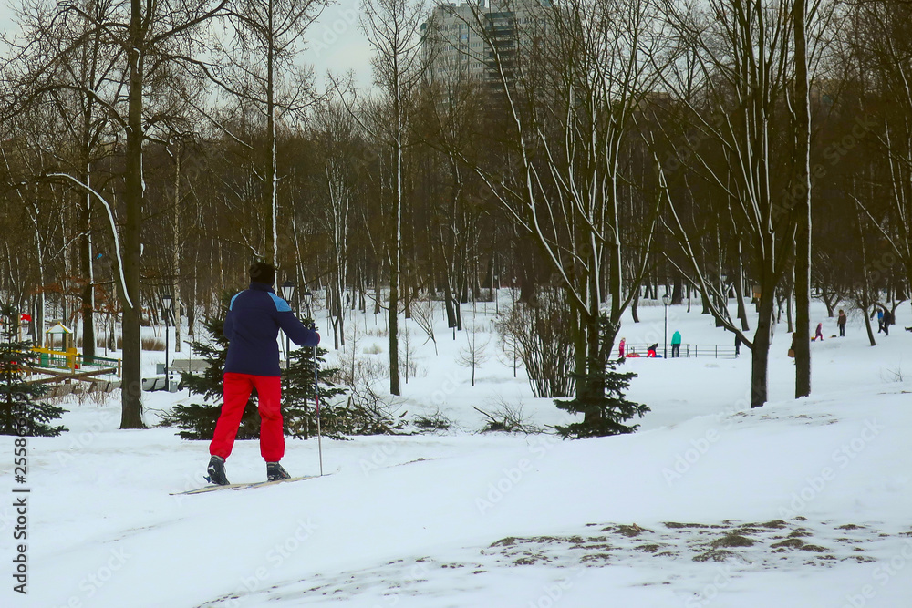 woman in red pants skiing in the winter park