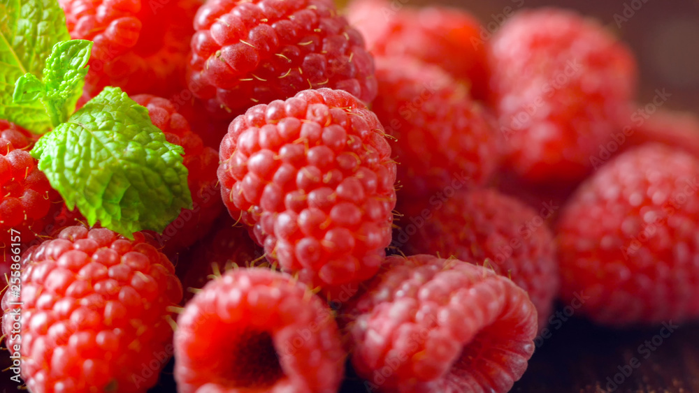 Macro closeup of summer fruit raspberries on wooden table. Macro closeup of summer fruit raspberries on wooden table.