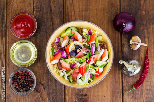 Photos Vegetable salad with surimi crab sticks.
