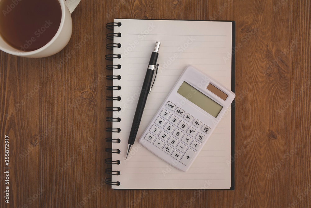 Top view workplace, Calculator and pen with notebook on wood desk background. Top view workplace, Calculator and pen with notebook on wood desk background.