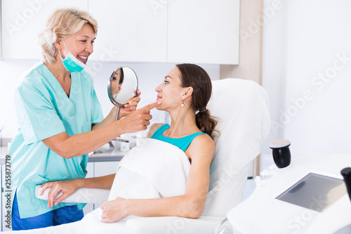 Cosmetician explaining treatment to patient