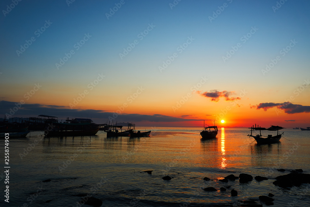 Beautiful sunrise on tropical beach Koh rong cambodia Landscape with longtail boats while sun is going up