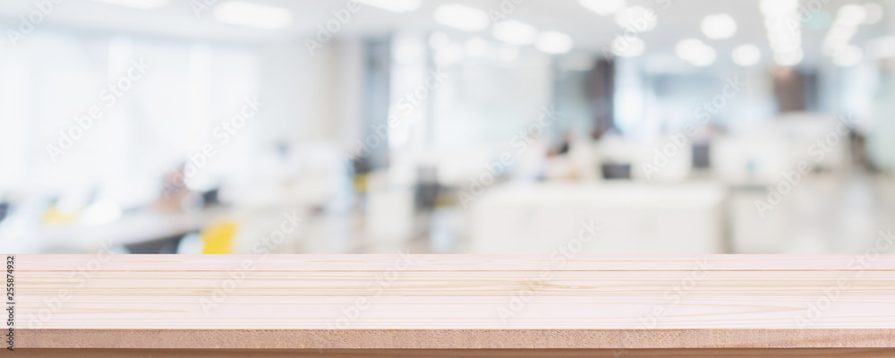 Empty wood table top and blur glass window wall in office building background - can used for display or montage your products.