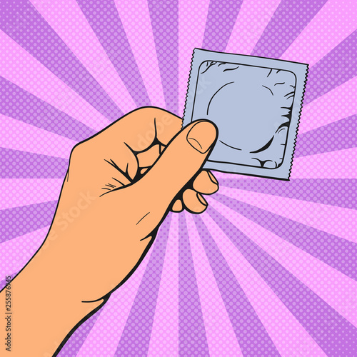 Hand holding condom. Pop art vintage vector illustration