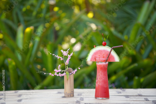 Fresh watermelon juice on the table in garden for relax photo