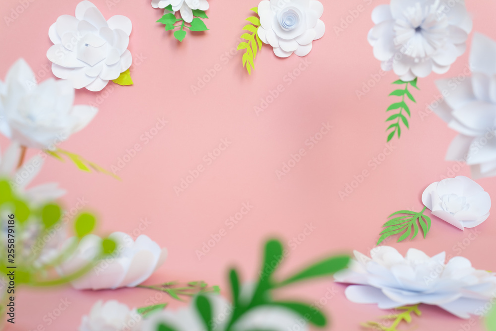 Fototapeta premium White paper flowers on pink background. Floral