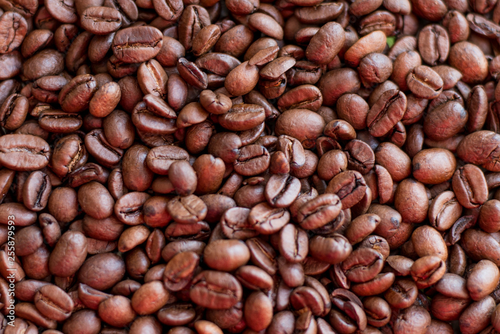 Texture of coffee beans scattered randomly. Brown texture. Texture of coffee beans scattered randomly. Brown texture.