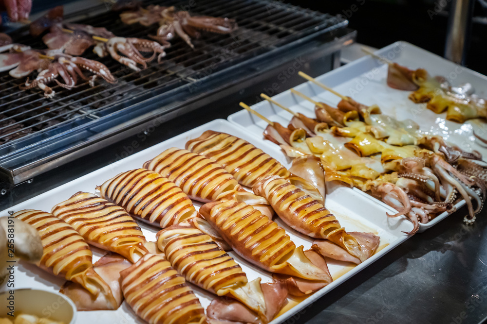 Grilled squid at night market street food stall