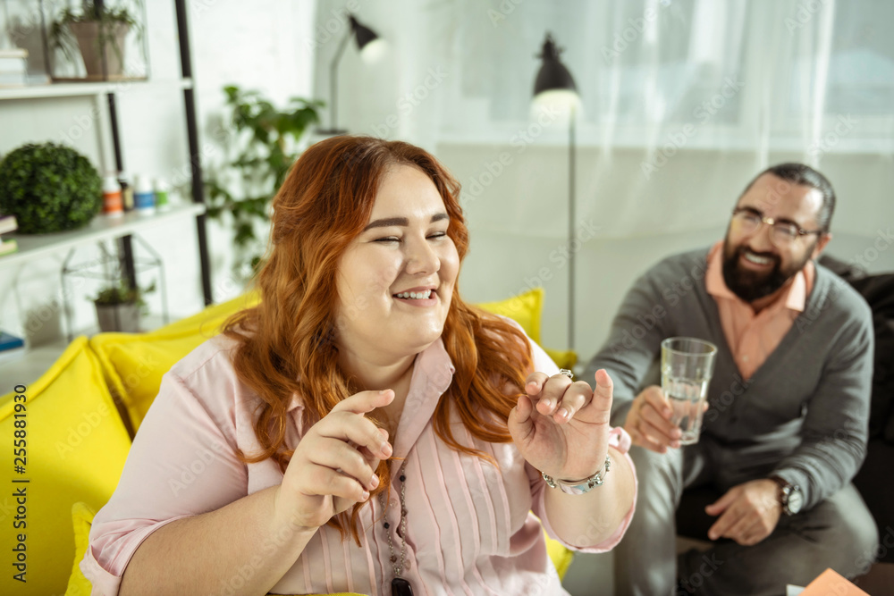 Charming red-haired girl visiting her therapist with pleasure Charming red-haired girl visiting her therapist with pleasure