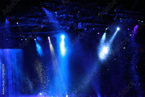 Fototapeta Naklejka Na Ścianę i Meble -  Blurred Concert light with colored spotlights and smoke. 