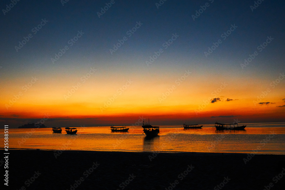 Sunrise on tropical beach Koh rong Cambodia, Landscape with longtail boats while sun is going up