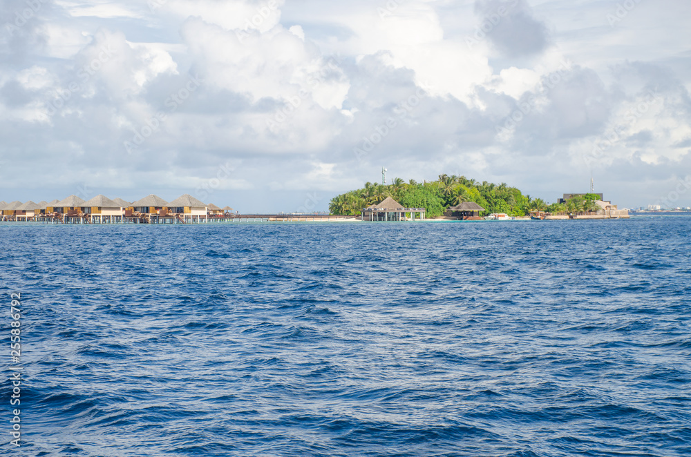 landscape the Indian Ocean with houses on water and the boat