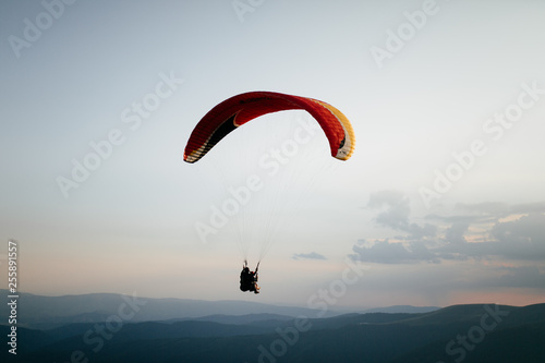 Hang glider pilot in mountains photo