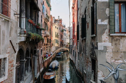 Panoramic view of Venice narrow canal with historical buildings and boat