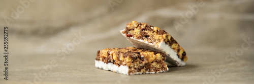 Muesli and cereal bar on marble stone background