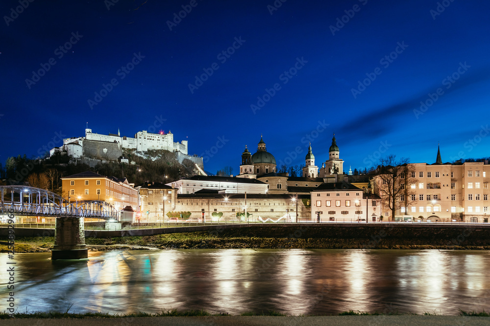 Night view in Salzburg: Historic old city and fortress Hohensalzburg, twilight hour