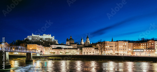 Night view in Salzburg: Historic old city and fortress Hohensalzburg, twilight hour