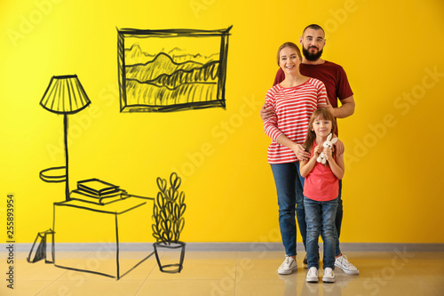Happy family near color wall
