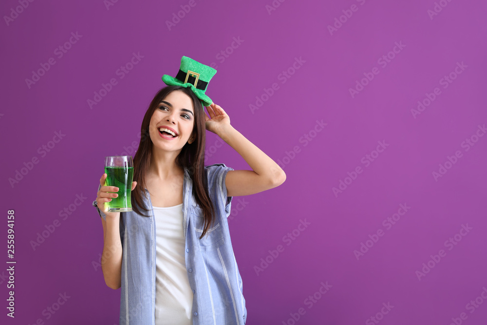 Beautiful young woman with green hat and glass of beer on color background. St. Patrick's Day celebration Beautiful young woman with green hat and glass of beer on color background. St. Patrick's Day celebration