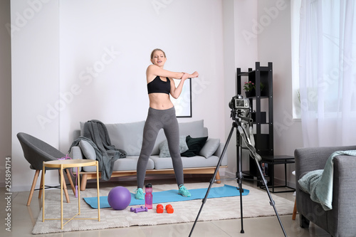 Young woman stretching arms...
