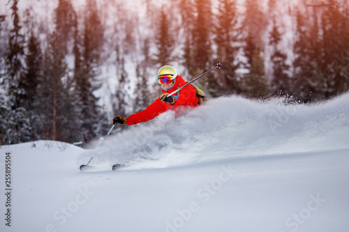 Winter sport, sharp braking skier, fresh powder snow. Action camera