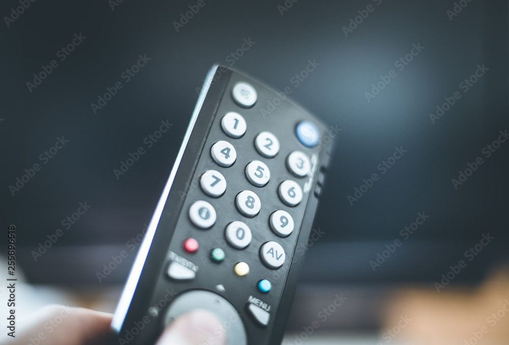 Male hand is holding TV remote control, smart TV. Male hand is holding TV remote control, smart TV.