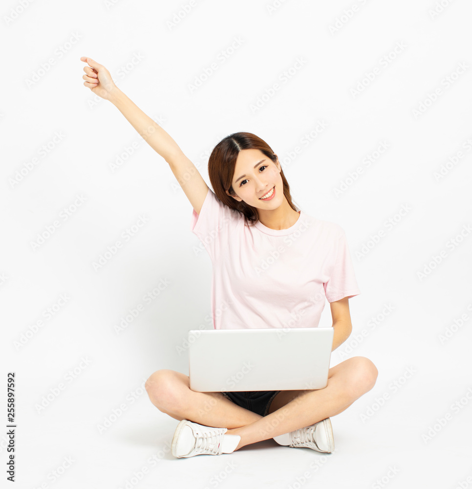 Happy young woman sitting on the floor using laptop Happy young woman sitting on the floor using laptop