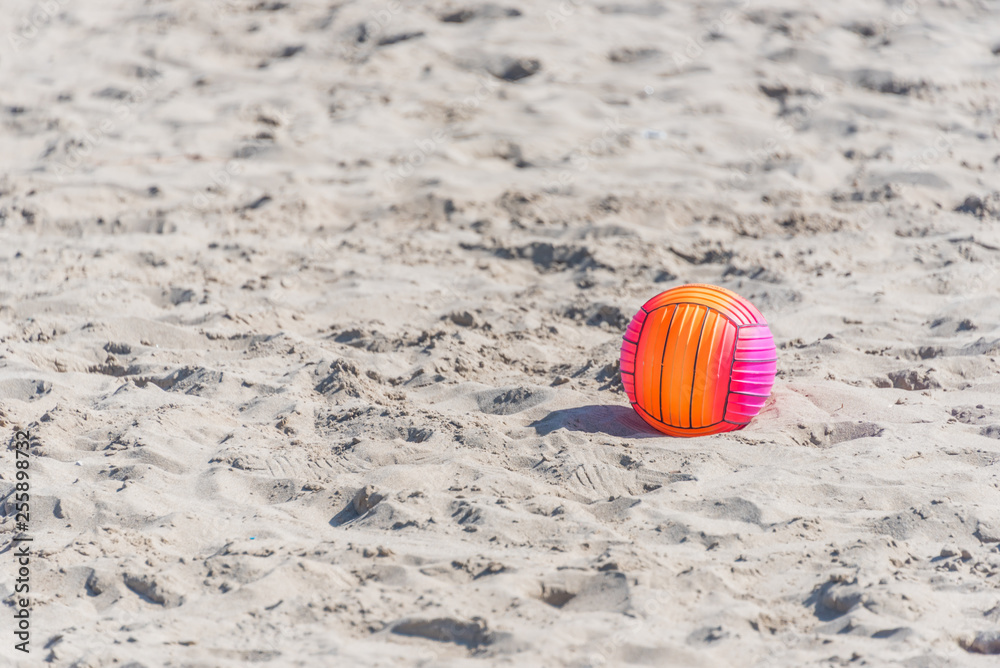 Bright Beach Ball on a Sandy Beach on a Sunny Day
