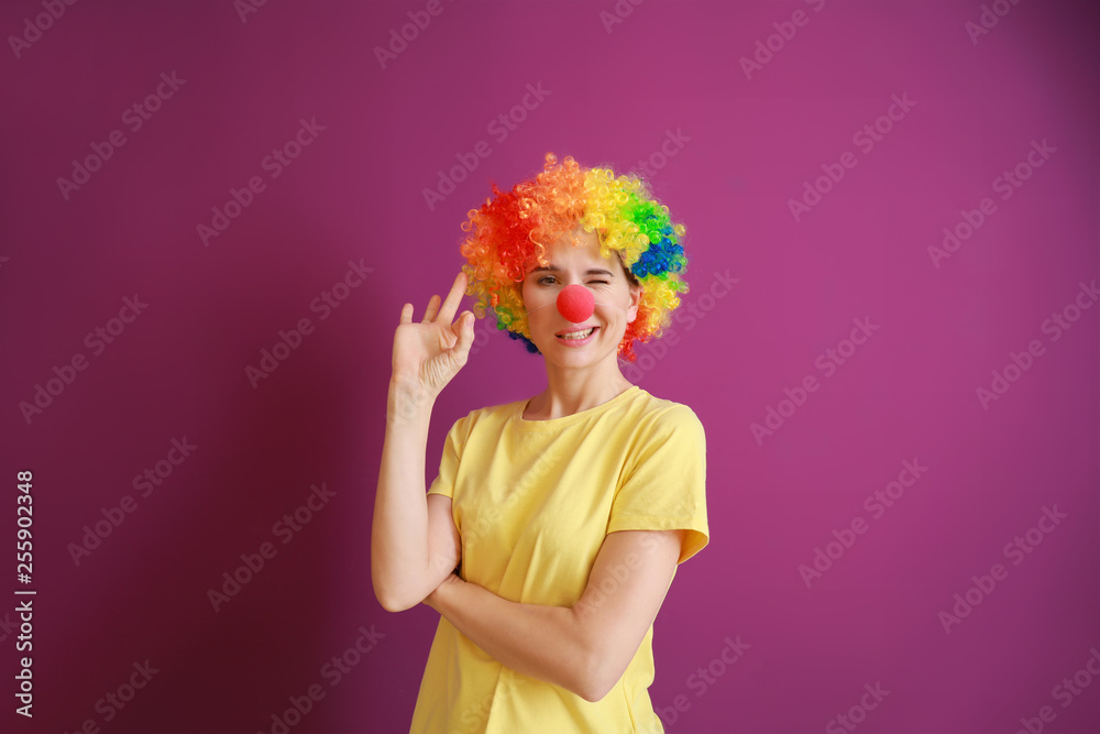 Funny woman with party decor for April Fools' Day on color background Funny woman with party decor for April Fools' Day on color background