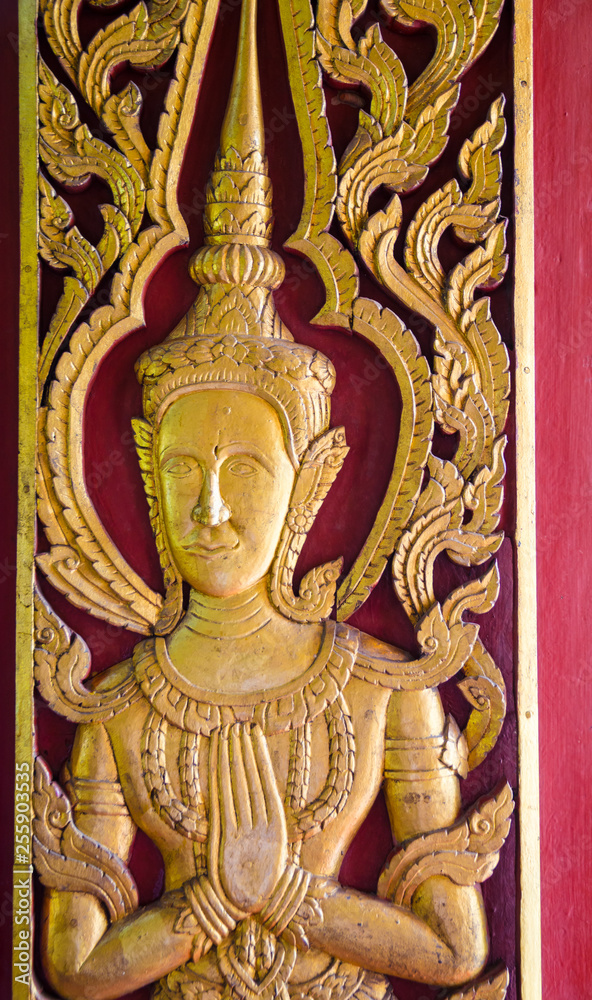Obraz premium wooden fairy statue on door of church