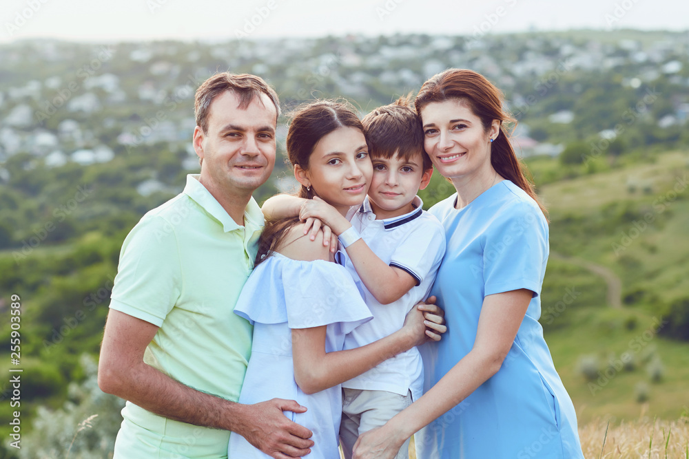 Portrait of a happy family sitting on nature. Portrait of a happy family sitting on nature.
