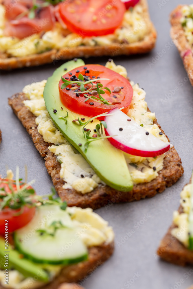 Sandwiches with cream cheese, vegetables and salami.