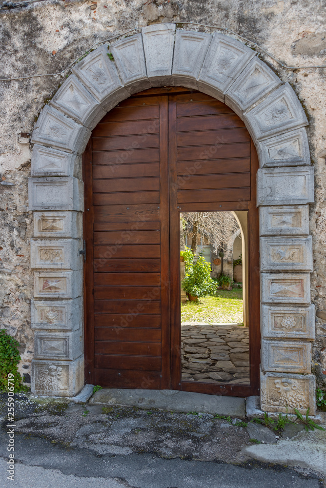 Ancient Doorway into a Garden in an Italian Village