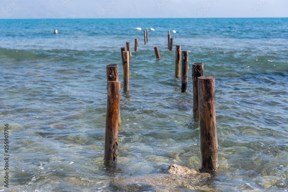 Old Posts for Dock into the Mediterranean Sea on the Southern Italian Coast Old Posts for Dock into the Mediterranean Sea on the Southern Italian Coast