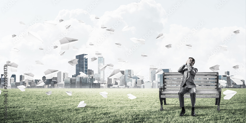 Young man in summer park on bench do not want to see anything Young man in summer park on bench do not want to see anything