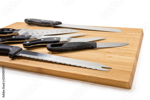 Fragment of wooden cutting board with different kitchen knives