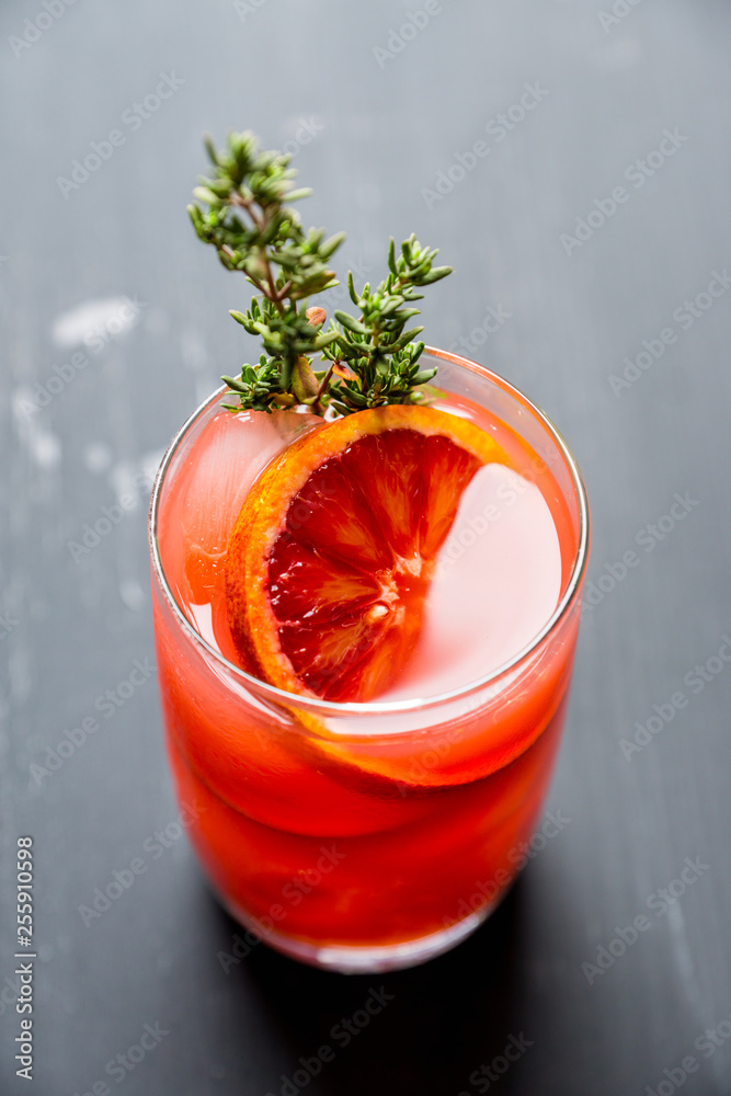 Bloody oranges beverage with thyme. Selective focus. Shallow depth of field. Bloody oranges beverage with thyme. Selective focus. Shallow depth of field.