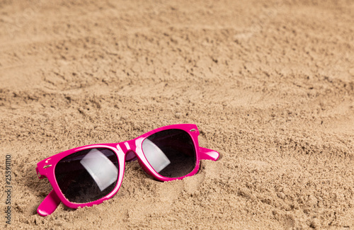sunglasses in sand at a beach