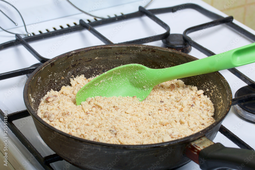 Cooking sponge cake. Cooking a cake of biscuit crumbs and milk jelly. On the surface of the table are the ingredients and cooking utensils.
