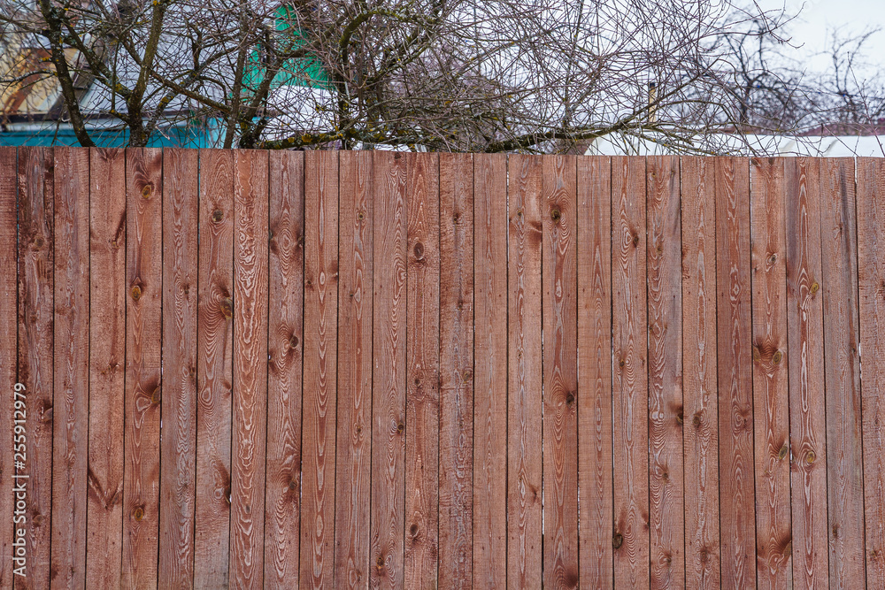 fence of painted boards around the garden