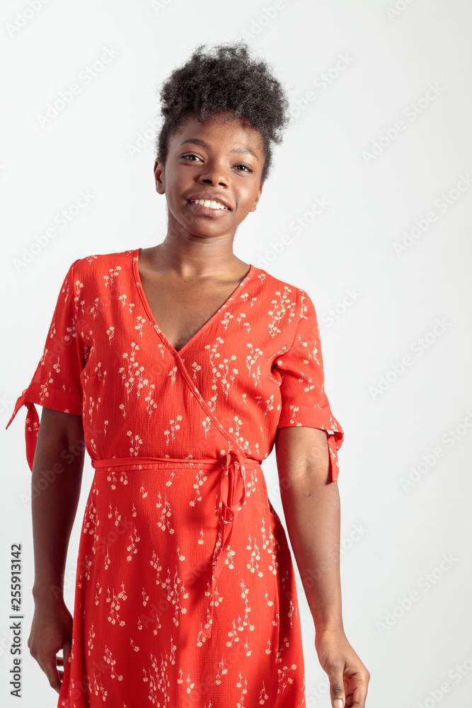 Smiling black woman looking at camera in red flowered dress Smiling black woman looking at camera in red flowered dress