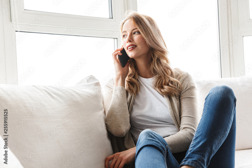 Beautiful young blonde woman relaxing on a couch Beautiful young blonde woman relaxing on a couch