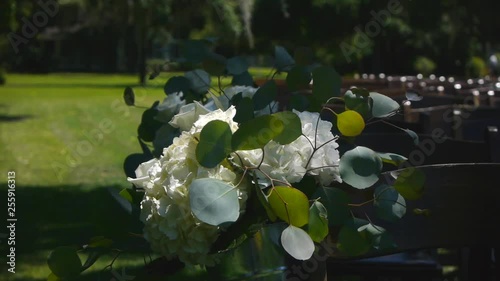 A cool breeze gently blows wedding flowers on a marsh in Pawley's Island, South Carolina, USA. photo