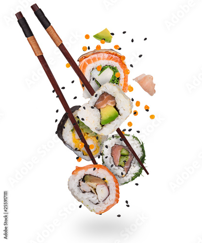 Pieces of delicious japanese sushi frozen in the air. Isolated on white background photo