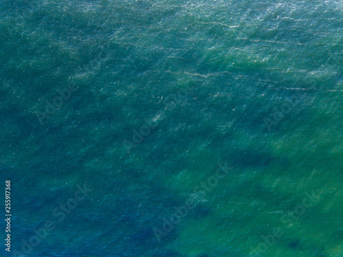 Aerial top view water surface background. Bird eye sea surface photo from drone. Turquoise ocean from above.