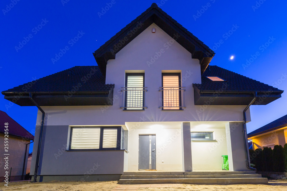 New house illuminated at night, Poland